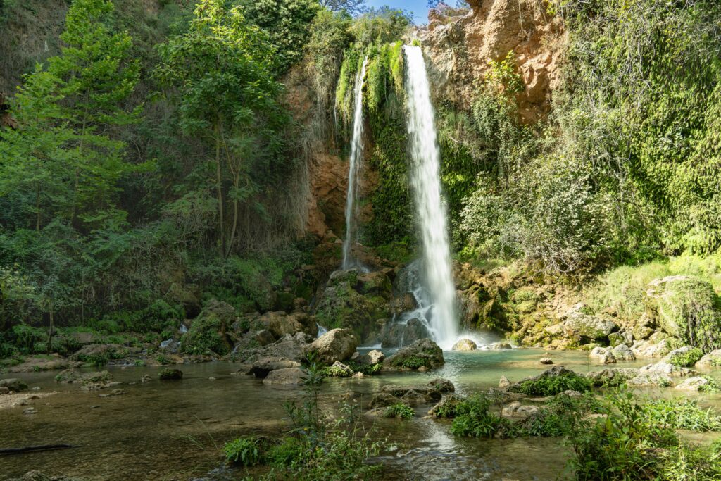 A stunning waterfall surrounded by lush greenery in Anna, Valencia.