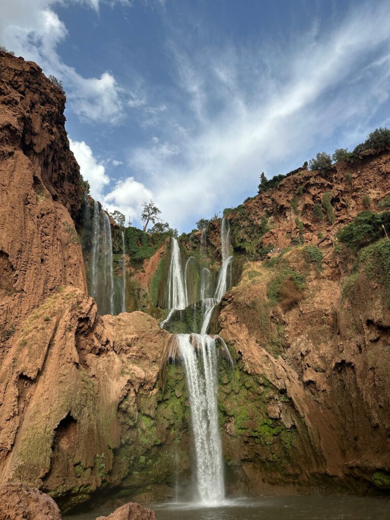 Experience the natural beauty and grandeur of Ouzoud Waterfalls cascading amidst lush Moroccan landscape.