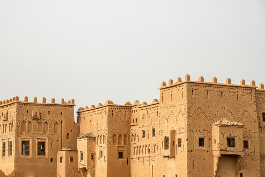 Explore a historic adobe fort in Morocco with unique architecture and desert backdrop.